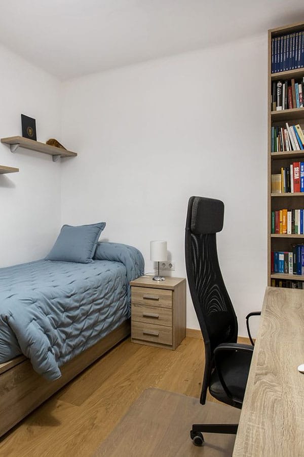 Habitación juvenil con cama, mesita de noche y zona de escritorio